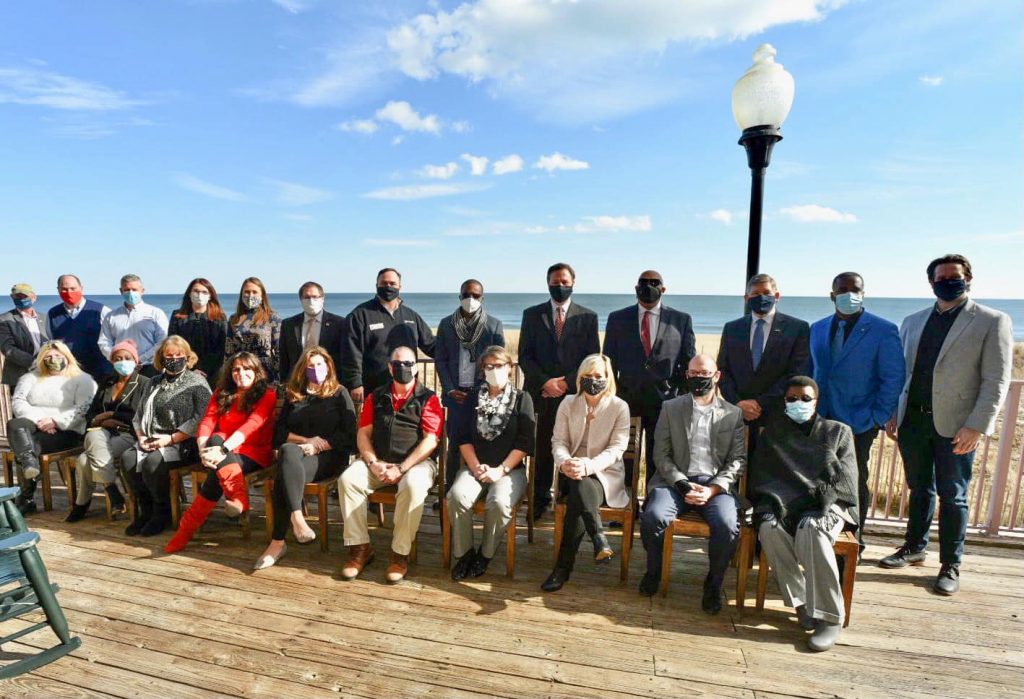 group of people sitting in front of bay in Salisbury MD for photo-op